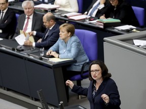 FILE - In this May 16, 2018 file photo Chair of the Social Democratic Party (SPD), Andrea Nahles, right, speaks at the plenary session of the German Bundestag in the Reichstags building in front of Foreign Minister Heiko Maas, Interior Minister Horst Seehofer, Finance Minister Olaf Scholz and German Chancellor Angela Merkel, from left, in Berlin. A decision to remove Germany's spy chief after he appeared to downplay recent far-right protests but give him a new government job is causing discontent in Chancellor Angela Merkel's government.
