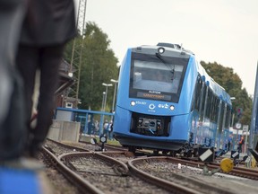 In this Sept. 16, 2018 photo a fuel cell train which is powered by hydrogen arrives in Bremervoerde, northern Germany. It is one of two trains that will go into regular service in 2019.