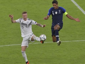 France's Raphael Varane, right, and Germany's Marco Reus challenge for the ball during the UEFA Nations League soccer match between Germany and France in Munich, Germany, Thursday, Sept. 6, 2018.