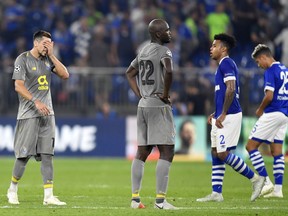 Porto midfielders Hector Herrera, left, and Danilo react after the Champions League group D soccer match between FC Schalke 04 and FC Porto at the Arena AufSchalke in Gelsenkirchen, Germany, Tuesday, Sept. 18, 2018.