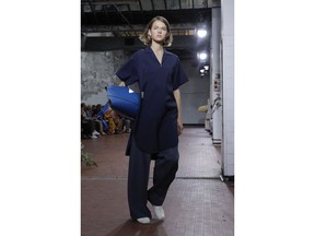 A model wears a creation as part of the Jil Sander women's 2019 Spring-Summer collection, unveiled during the Fashion Week in Milan, Italy, Wednesday, September 19, 2018.