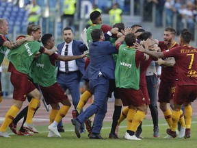 Roma players celebrate after Aleksandar Kolarov scored his side's 2nd goal, during the Serie A soccer match between Roma and Lazio, at the Rome Olympic Stadium, Saturday, Sept. 29, 2018.