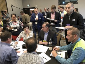 David Stern, top right, a cyber security official with the Department of Homeland Security, works with Colorado county elections officials at a security training exercise in Denver on Thursday, Sept. 6, 2018. State, county and federal elections officials worked on security scenarios to prepare for the November midterm elections.