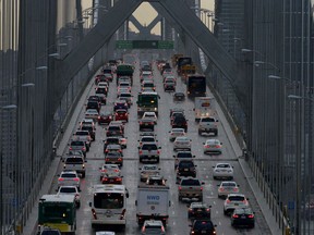 FILE - In this Dec. 10, 2015 file photo, vehicles make their way westbound on Interstate 80 across the San Francisco-Oakland Bay Bridge as seen from Treasure Island in San Francisco. California is telling automakers they must still comply with the state's strict vehicle mileage standards even if President Donald Trump rolls them back. The action Friday, Sept. 28, 2018, by the California Air Resources Board was widely expected. It sets up likely court battle if the Trump administration follows through with an attempt to revoke California's unique authority to set its own vehicle emissions standards.