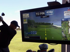 Kevin Haime owner of the Kevin Haime Golf Centre swings his golf club to demonstrate Topgolf technology, in Kanata, Ont. on Friday, September 7, 2018.