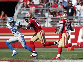 San Francisco 49ers running back Matt Breida goes on a 66-yard touchdown run as wide receiver Pierre Garcon blocks Detroit Lions defensive back Nevin Lawson (24) during the second half of an NFL football game in Santa Clara, Calif., Sunday, Sept. 16, 2018.