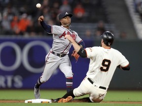 Atlanta Braves shortstop Ozzie Albies (1) forces out San Francisco Giants first baseman Brandon Belt (9) on a Evan Longoria (10) fielder's choice in the first inning of a baseball game in San Francisco, Monday, Sept. 10, 2018.