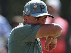 Rickie Fowler reacts to missing his birdie putt on the first hole during the first round of the Tour Championship golf tournament at East Lake Golf Club, in Atlanta, Thursday, Sept. 20, 2018.