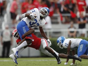 Middle Tennessee wide receiver Patrick Smith (37) is tackle by Georgia linebacker David Marshall (51) after a catch in the first half of an NCAA college football game Saturday, Sept. 15, 2018, in Athens, Ga.