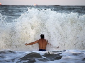 Body surfer Andrew Vanotteren, of Savannah, Ga., crashes into waves from Hurricane Florence, Wednesday, Sept., 12, 2018, on the south beach of Tybee Island, Ga. Vanotteren and his friend Bailey Gaddis said the waves have gotten bigger and better every evening as the storm approaches.