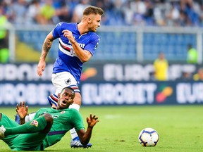 Sampdoria's Karol Linetty, top, and Fiorentina's Edmilson Fernandes vie for the ball during the Serie A soccer match between Sampdoria and Fiorentina, at the Luigi Ferraris stadium in Genoa, Italy, Wednesday, Sept. 19, 2018.