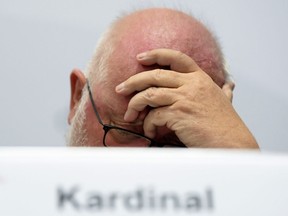Cardinal Reinhard Marx, head of the german bishops' conference, ponders during a press conference on a report on sexual abuse of minors within the German Catholic Church in Fulda, central Germany, Tuesday, Sept. 25, 2018.