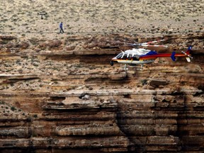 In this June 23, 2013, file photo, daredevil Nik Wallenda crosses a tightrope high above the Little Colorado River Gorge, Ariz., on the Navajo Nation outside the boundaries of Grand Canyon National Park.