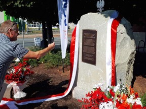 A man takes a photo of a monument honouring the Polish-Canadian community in Halifax, N.S., on Sunday, September 16, 2018.