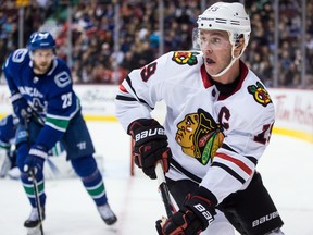 In this Feb. 1 file photo, Chicago Blackhawks captain Jonathan Toews skates with the puck after drawing a slashing penalty against the Vancouver Canucks.