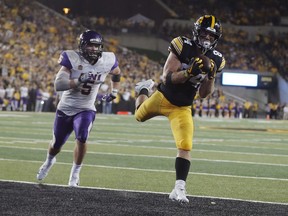 Iowa wide receiver Nick Easley, right, catches a 14-yard touchdown pass ahead of Northern Iowa defensive back Korby Sander, left, during the second half of an NCAA college football game, Saturday, Sept. 15, 2018, in Iowa City, Iowa.