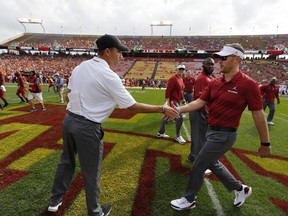Iowa State head coach Matt Campbell, left, meets with Oklahoma head coach Lincoln Riley, right, before an NCAA college football game, Saturday, Sept. 15, 2018, in Ames, Iowa.