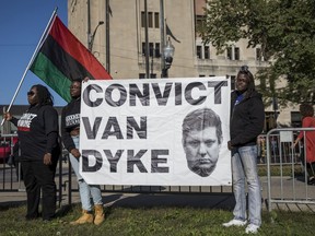 Chicago Police Officers stand guard as protesters rally outside the Leighton Criminal Courthouse in Chicago during the Officer Jason Van Dyke murder trial, Monday morning, Sept. 24, 2018.
