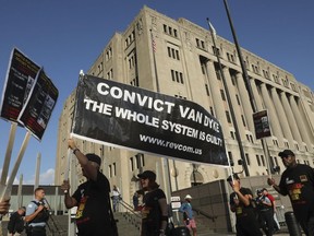 Protesters gather as Jason Van Dyke arrives for the start of his trail in the shooting death of Laquan McDonald at the Leighton Criminal Court Building in Chicago Monday, Sept. 17, 2018.