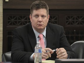 Chicago police officer Jason Van Dyke listens during his trial for the shooting death of Laquan McDonald at the Leighton Criminal Court Building in Chicago on Monday, Sept. 24, 2018. Lawyers for the white Chicago police officer charged with murder in the shooting of McDonald, a black teenager, opened their defense case Monday with a witness questioning the thoroughness and accuracy of the autopsy.