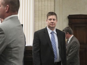 In this Friday, Sept. 14, 2018, photo Chicago police officer Jason Van Dyke walks towards Cook County Judge Vincent Gaughan's bench during a hearing at the Leighton Criminal Court Building in Chicago for his upcoming murder trial in the 2014 shooting of black teenager Laquan McDonald. Gaughan is at the center of one of the city's biggest trials in decades. The trial caps a career and a life for Gaughan that have included chapters as an engineering student, war hero, young man who had his own brush with the law, attorney and judge.