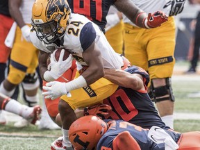 Kent State's Raekwon James, (24) runs the ball and is brought down by Illinois defenders in the second quarter of an  NCAA college  football in Champaign, Ill., Saturday, Sept. 1, 2018.
