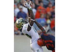 South Florida's Randall St. Felix, left, makes a catch over Illinois's Jartavius Martin during the second half of an NCAA college football game Saturday, Sept. 15, 2018, in Chicago.