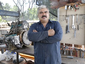 Ruben Moyoroqui poses for a portrait in his auto repair shop in Tucson, Ariz., on Tuesday, Sept. 4, 2018.