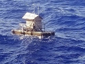 In this undated photo released by Indonesian Consulate General in Osaka, 18-year-old Aldi Novel Adilang is seen on a wooden fish trap floating in the waters near the island of Guam.