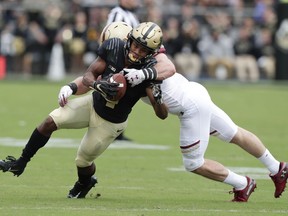 Purdue wide receiver Rondale Moore (4) is tacked by Boston College linebacker Connor Strachan (13) during the first half of an NCAA college football game in West Lafayette, Ind., Saturday, Sept. 22, 2018.