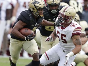 Purdue wide receiver Rondale Moore (4) pushes off Boston College linebacker Isaiah McDuffie (55) during the first half of an NCAA college football game in West Lafayette, Ind., Saturday, Sept. 22, 2018.