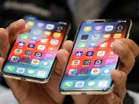 The iPhone XS, left, and XS Max are displayed side to side during an event to announce new products at Apple headquarters Wednesday.
