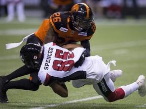 BC Lions defensive back Anthony Orange (26) tackles Ottawa Redblacks wide receiver Diontae Spencer (85) during the first half of CFL football action in Vancouver, B.C., on Friday, Sept. 7, 2018.