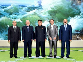 This picture, taken by North Korea's official Korean Central News Agency (KCNA) on July 24, 2013 shows North Korean leader Kim Jong-Un (C) posing with Syrian delegation members, led by Abdullah al-Ahmar (2nd L), deputy general secretary of the Syria's Baath Arab Socialist Party in Pyongyang.