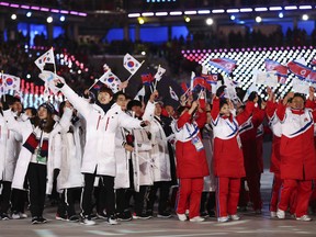 In this Feb. 25 file photo, members of the North and South Korean Olympic delegations wave flags during the closing ceremony of the Pyeongchang Olympics.