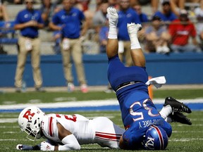 Kansas fullback Caperton Humphrey (35) is upended by Rutgers defensive back Kiy Hester (23) during the first half of an NCAA college football game Saturday, Sept. 15, 2018, in Lawrence.