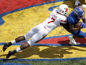 Kansas running back Pooka Williams Jr. (1) is tackled by Rutgers defensive lineman Elorm Lumor (7) during the second half of an NCAA college football game Saturday, Sept. 15, 2018, in Lawrence, Kan. Kansas won 55-14.