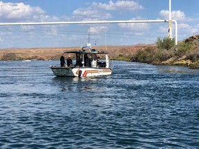 In this photo released by the San Bernardino County, Calif., Sheriff's Office, shows search and recovery operations Monday, Sept. 3, 2018, for three people missing after two boats collided Saturday evening on the Colorado River along the California-Arizona border near Topock, Ariz. The body of a California woman was found Monday, authorities said. A search continued for two other women and one man. (San Bernardino County Sheriff's Office via AP)