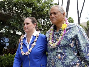 FILE - In this Oct. 20, 2017, file photo, former Honolulu Police Chief Louis Kealoha, right, and his wife, Katherine, leave federal court in Honolulu. Katherine Kealoha is resigning from her job as a deputy prosecutor nearly a year after a grand jury indicted the couple on corruption-related charges. The Kealohas are accused of orchestrating the framing of a relative for a mailbox theft. Prosecutors also allege Kealoha bilked relatives, banks and children whose trusts she controlled.