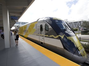 FILE - In this Jan. 11, 2018 file photo a Brightline train is shown at the station, in Fort Lauderdale, Fla. A plan to build a high-speed train between Southern California and Las Vegas is back on track now that a private rail company has taken over the project. Brightline announced Wednesday, Sept. 19, 2018, that it has acquired the rights to XpressWest's 185-mile federally approved rail corridor along Interstate 15.