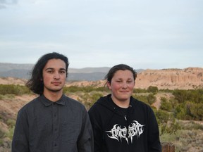 In this Friday, May 11, 2018 file photo, Thomas Gray, left, and Lloyd Gray stand together with the Sangre de Cristo Mountains in the background outside Santa Fe, N.M. An attorney for two Native American brothers pulled from a Colorado State University tour has told the school that campus officers violated the teens' constitutional rights when they questioned and patted them down without any suspicion of a crime. A letter sent Wednesday, Sept. 19, 2018, from an American Civil Liberties Union attorney calls for the university to revisit its campus police policies and training to avoid a situation similar to the April 30 encounter.
