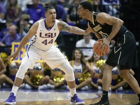 FILE - In this Feb. 20, 2018, file photo, LSU forward Wayde Sims (44) defends against Vanderbilt forward Jeff Roberson (11) during an NCAA college basketball game, in Baton Rouge, La. LSU basketball player Wayde Sims has died after he was shot near the campus of another school in Baton Rouge. Police say in a news release that the 20-year-old Sims was shot around 12:30 a.m. Friday, Sept. 28, 2018, near the campus of Southern University. Sgt. Don Coppola Jr. said Sims was taken to a hospital with an apparent gunshot wound and died.
