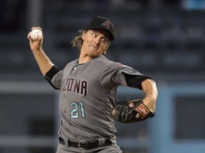 Arizona Diamondbacks starting pitcher Zack Greinke throws to the plate during the first inning of a baseball game against the Los Angeles Dodgers, Friday, Aug. 31, 2018, in Los Angeles.