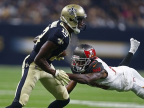 New Orleans Saints wide receiver Michael Thomas (13) carries against Tampa Bay Buccaneers cornerback Carlton Davis in the first half of an NFL football game in New Orleans, Sunday, Sept. 9, 2018. The Buccaneers won 48-40.