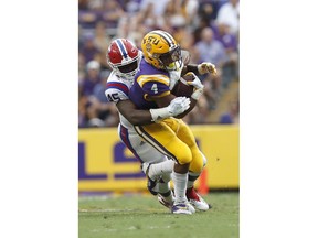 LSU running back Nick Brossette (4) is tackled by Louisiana Tech defensive end Jaylon Ferguson (45) in the first half of an NCAA college football game in Baton Rouge, LA., Saturday, Sept. 22, 2018.