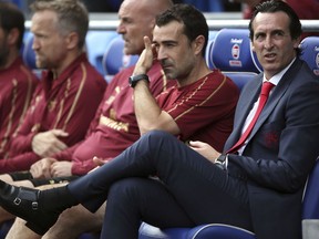 Arsenal manager Unai Emery, right, attends a Premier League soccer match between Cardiff City and Arsenal, at the Cardiff City Stadium, Wales, Sunday, Sept. 2, 2018.