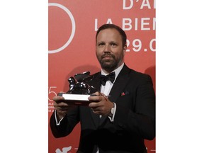 Director Yorgos Lanthimos holds the Silver Lion Best Director award for 'The Favourite' at the awards photo call of the 75th edition of the Venice Film Festival in Venice, Italy, Saturday, Sept. 8, 2018.