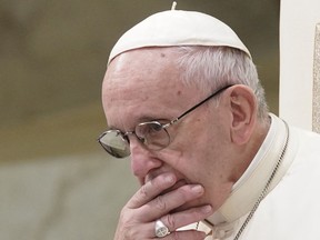 FILE - In this Aug. 22, 2018 file photo, Pope Francis is caught in pensive mood during his weekly general audience at the Vatican. Francis' papacy has been thrown into crisis by accusations that he covered-up sexual misconduct by ex-Cardinal Theodore McCarrick.