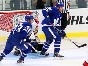 Leafs centre John Tavares, right,  and Nazem Kadri crowd Senators goalie Mike Condon during the Kraft Hockeyville game in Lucan on Tuesday night.