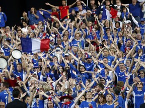 Supporters of the French tennis team wave before the Davis Cup France against Spain, Friday, Sept.14, 2018 in Lille, northern France.